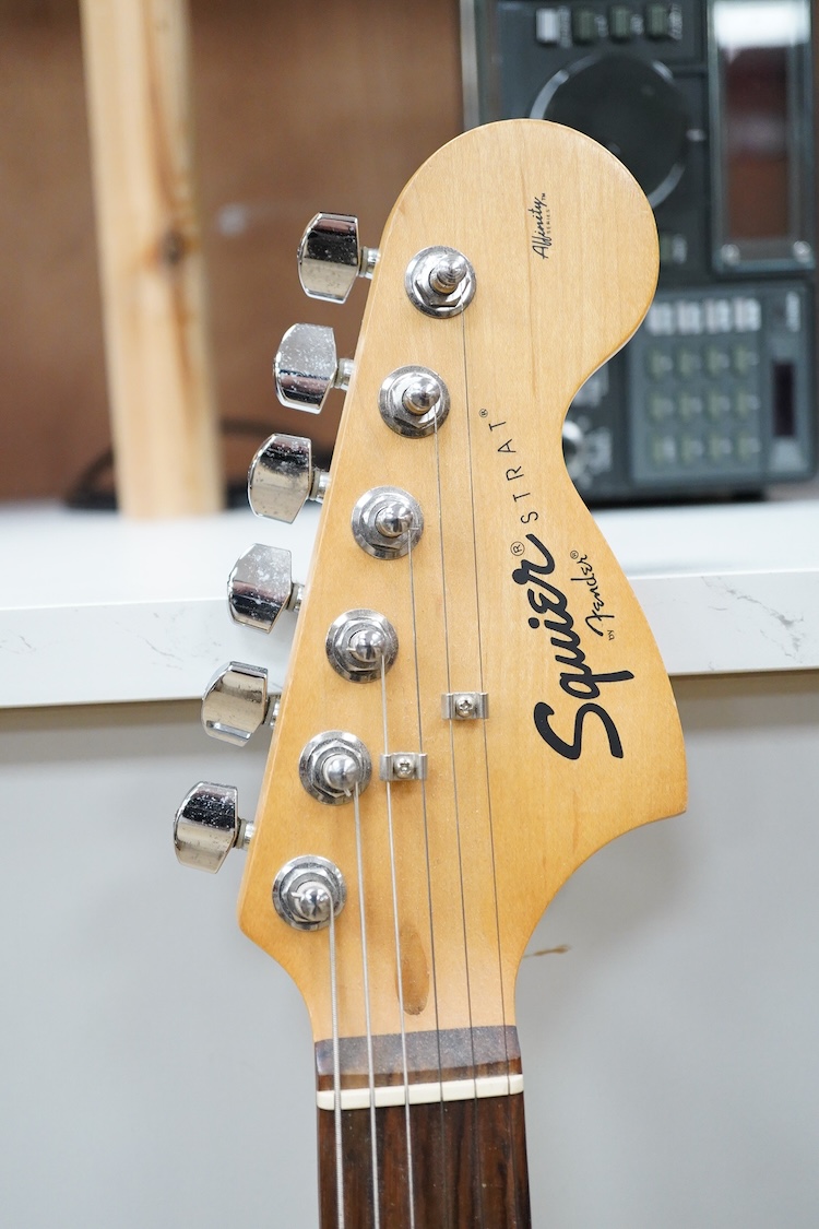A Fender Squire electric guitar, with a Kinsman soft case, together with a Peavey VYPYR 15W modelling amplifier